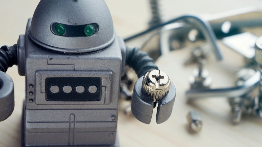 Two engineers in a small robotics workshop